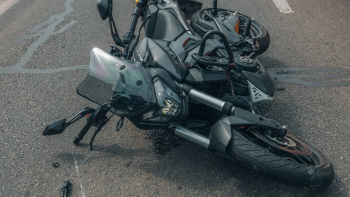 perde il controllo dello scooter e finisce contro auto in sosta